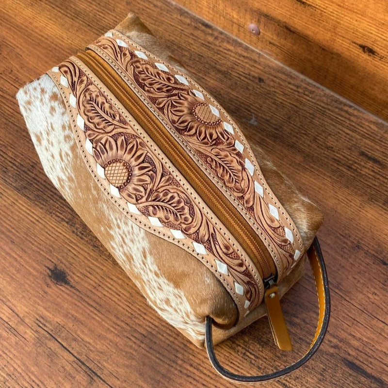 Golden Cowhide Western Luxe Leather Toiletry Bag featuring intricate hand-tooled detailing and a durable zipper, perfect for stylish organization.