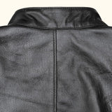 Close-up of the back collar and seam details of a black leather jacket.