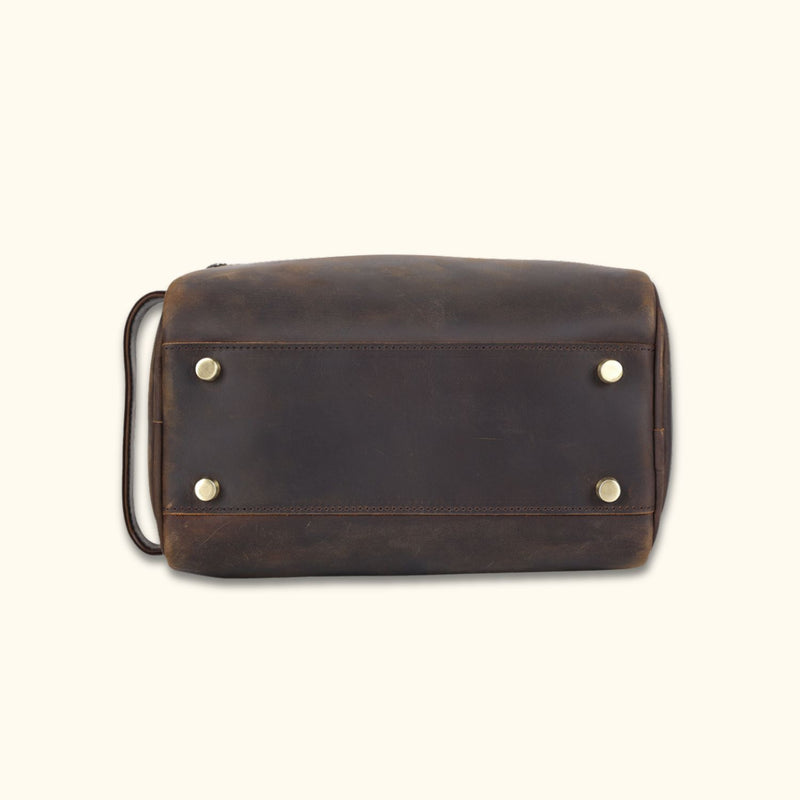 Bottom view of the High Plains Leather Toiletry Bag showcasing its reinforced brass feet for added stability and protection.