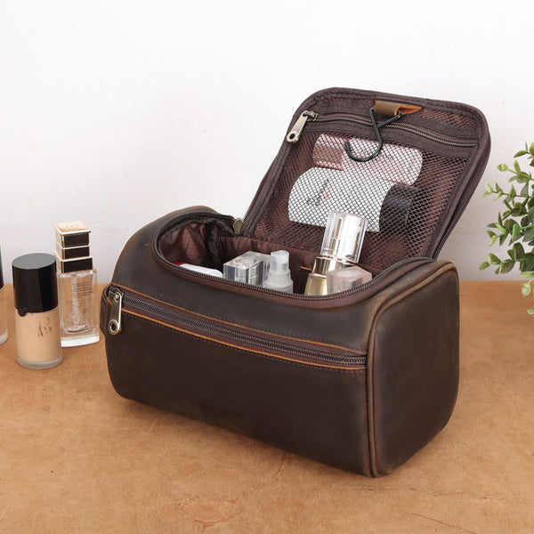 The High Plains Leather Toiletry Bag sits open on a dresser, showcasing its durable full-grain leather, organized compartments, and ample space for toiletries and cosmetics.