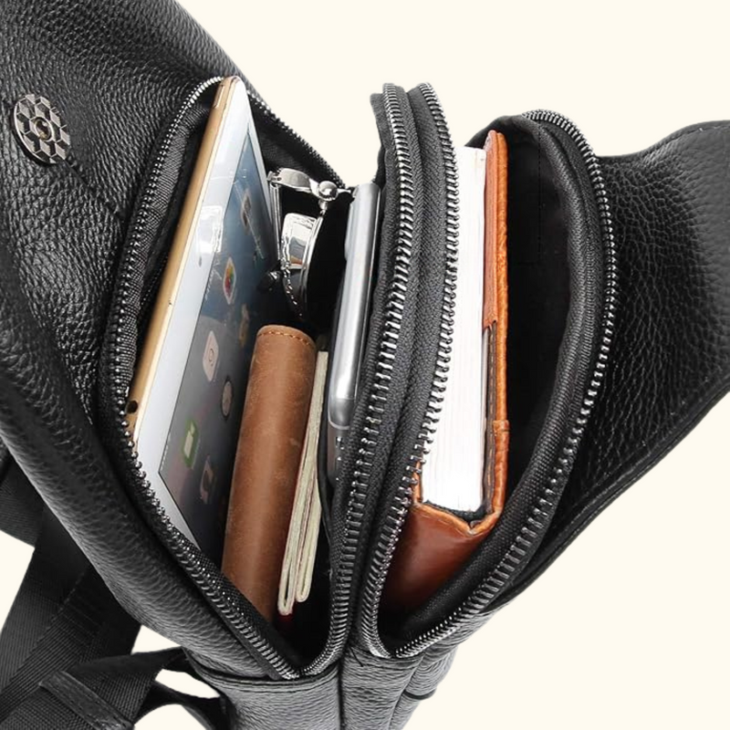 Interior view of the Western Adventure Leather Sling Bag, showing organized storage with an iPad, notebook, and other essentials inside the compartments.