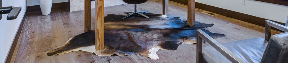 Luxurious cowhide rug collection banner featuring a dark-toned cowhide in a contemporary home office