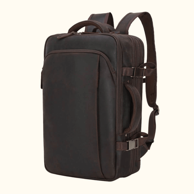 The Stetson Peak - Expandable Men's Leather Backpack in dark brown, front view showcasing sleek design, multiple compartments, and adjustable straps.