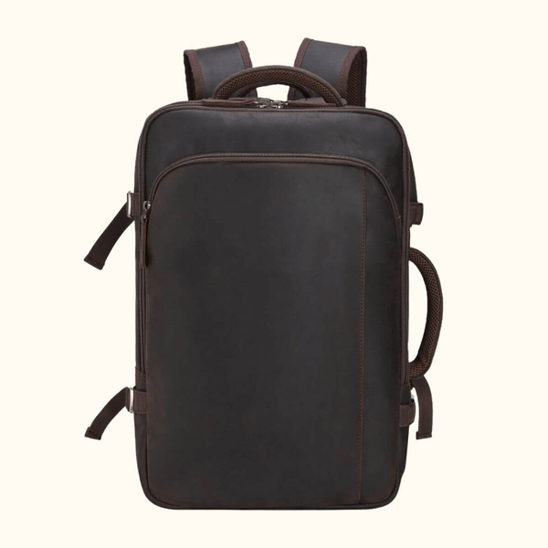 The Stetson Peak - Expandable Men's Leather Backpack in dark brown, front view displaying the sleek and minimalistic design with smooth leather surface and secure zippers.