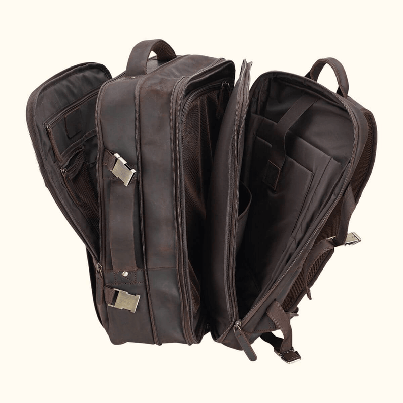 The Stetson Peak - Expandable Men's Leather Backpack in dark brown, open view showing multiple spacious compartments, internal pockets, and secure buckles for organized storage.