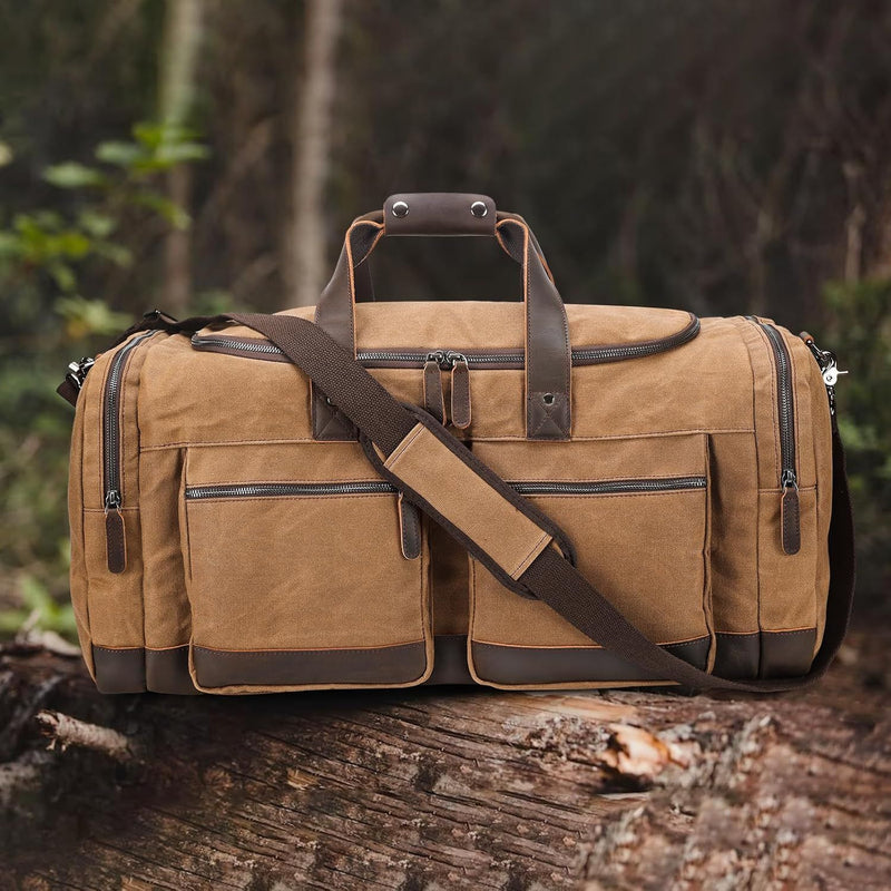 The Weekender - Waxed Canvas Leather Duffel resting on a log in a natural outdoor setting, demonstrating its rugged durability and versatile style for both travel and adventure.