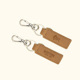 Western Leather Keychain in light brown with silver hardware, highlighting the sleek design and embossed logo.